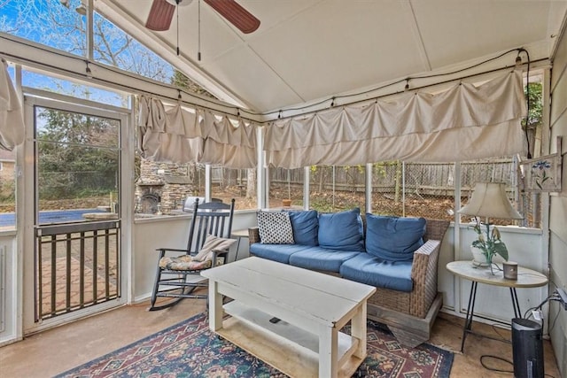 sunroom with a wealth of natural light, ceiling fan, and vaulted ceiling