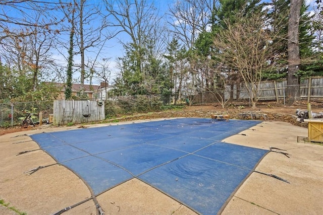 view of swimming pool with a patio and a fenced backyard