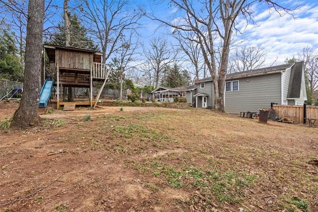 view of yard featuring a playground and fence