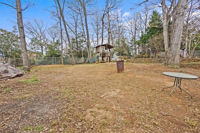 view of yard with a playground and fence