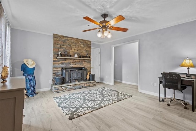 interior space with ceiling fan, baseboards, wood finished floors, and crown molding