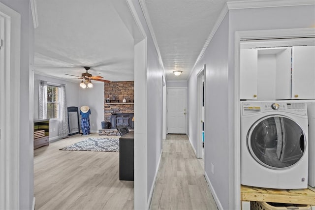 laundry area with washer / dryer, light wood-type flooring, and crown molding