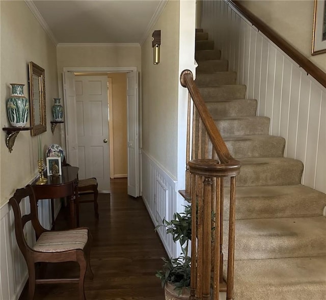 hall featuring a wainscoted wall, stairway, wood finished floors, and ornamental molding