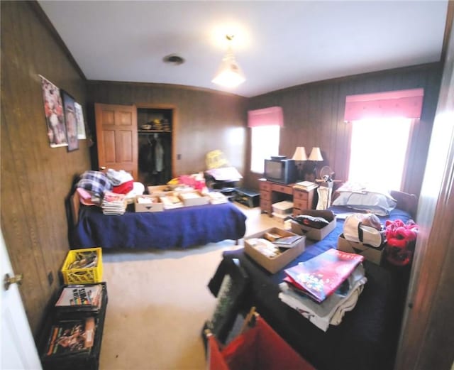 bedroom with a closet and wood walls