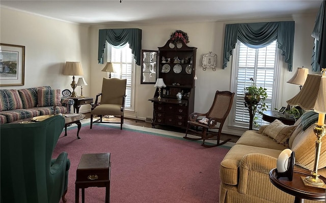 carpeted living area featuring plenty of natural light and crown molding