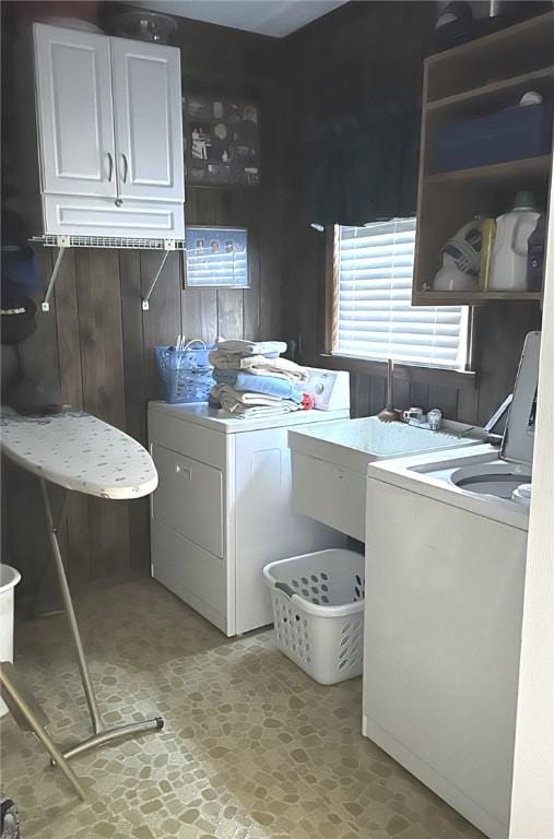 laundry area featuring a sink, cabinet space, and washing machine and clothes dryer