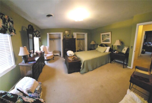 bedroom with visible vents, carpet floors, and baseboards