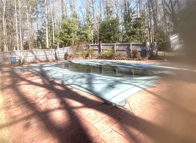 view of pool featuring a patio, a fenced backyard, and a fenced in pool