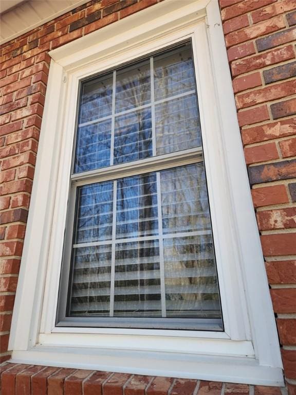 exterior details featuring brick siding