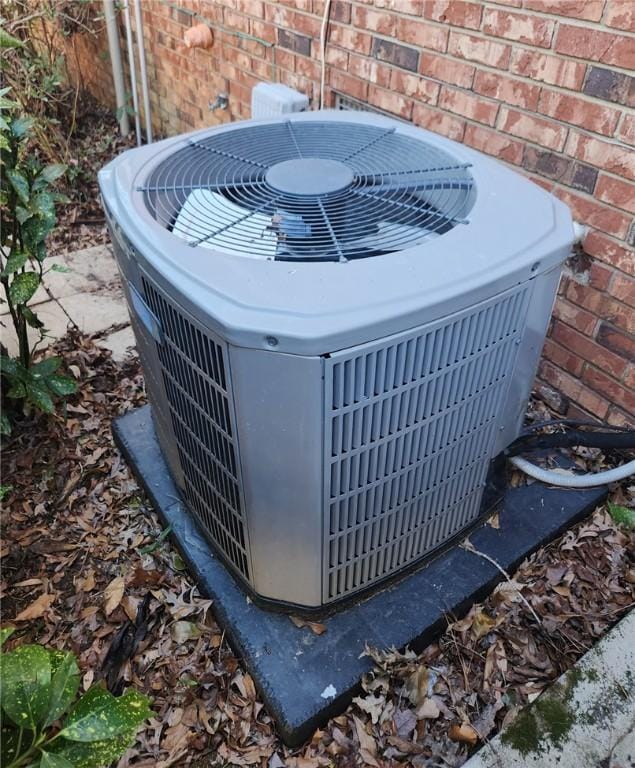 exterior details with central air condition unit and brick siding