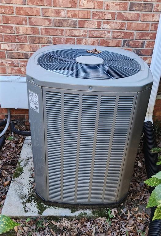 exterior details with central AC unit and brick siding