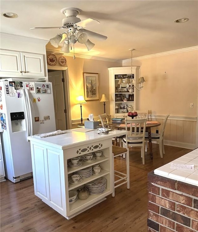 kitchen featuring open shelves, white fridge with ice dispenser, ornamental molding, and dark wood finished floors