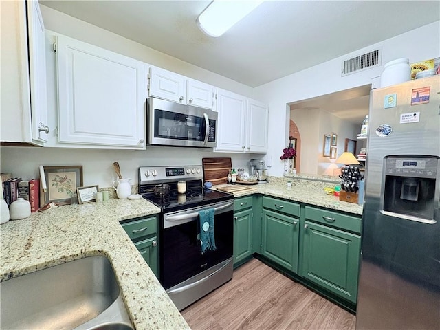 kitchen featuring visible vents, appliances with stainless steel finishes, green cabinets, and white cabinets