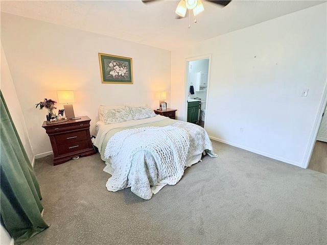 carpeted bedroom with connected bathroom, baseboards, and ceiling fan