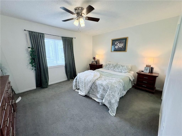 carpeted bedroom featuring baseboards, a textured ceiling, and a ceiling fan