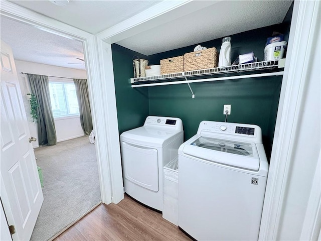 washroom with laundry area, carpet flooring, wood finished floors, and washer and clothes dryer