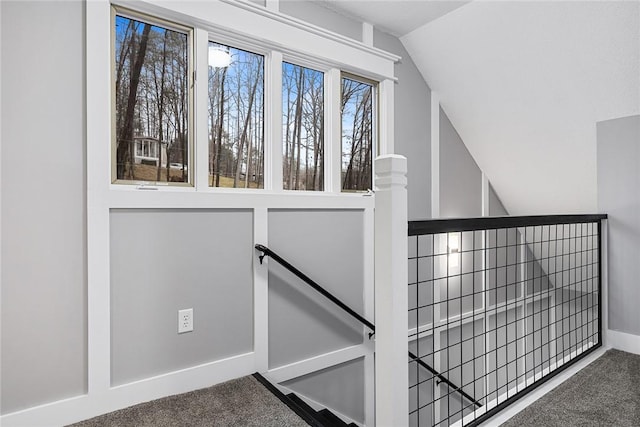 staircase featuring carpet floors and lofted ceiling