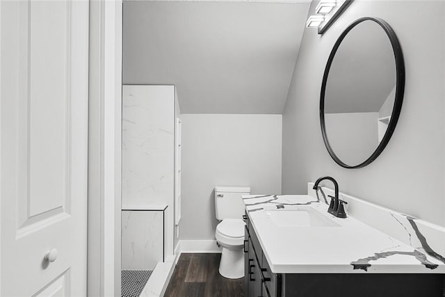 bathroom featuring vanity, toilet, wood finished floors, and baseboards