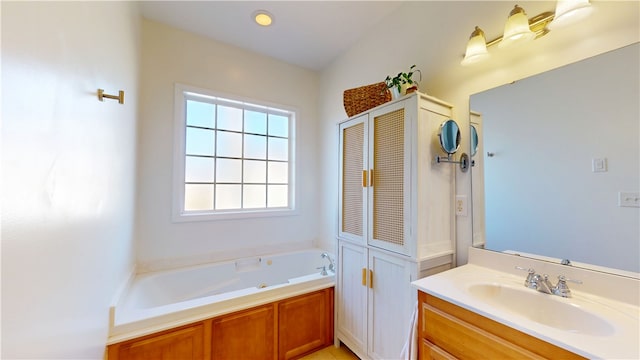 bathroom with a closet, a garden tub, and vanity