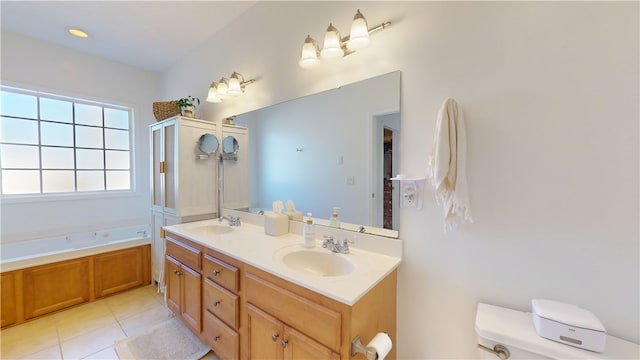 bathroom with a bath, tile patterned flooring, toilet, and a sink