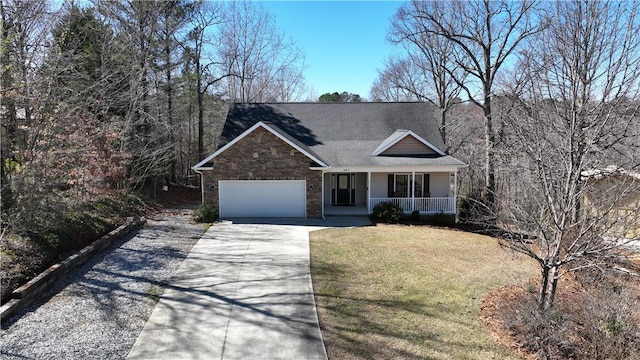 view of front of home with driveway, stone siding, covered porch, a front yard, and an attached garage