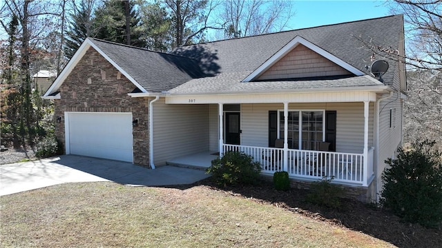 view of front facade with driveway, stone siding, a porch, roof with shingles, and a garage