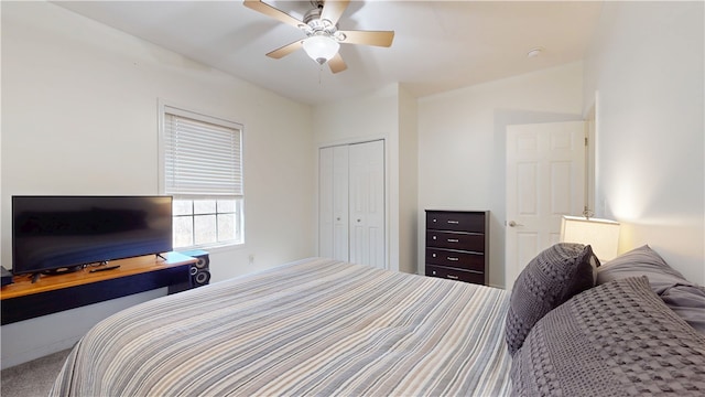 carpeted bedroom featuring a closet and ceiling fan