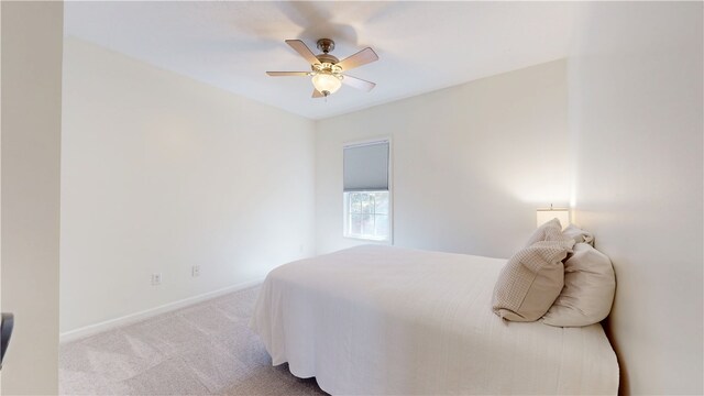 carpeted bedroom featuring a ceiling fan and baseboards