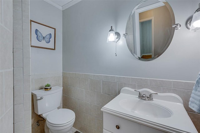 bathroom featuring toilet, tile walls, ornamental molding, and vanity