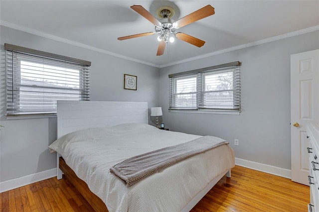 bedroom featuring baseboards, light wood-style floors, and ornamental molding