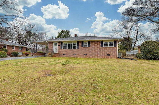 ranch-style home with a carport, a front lawn, crawl space, aphalt driveway, and brick siding