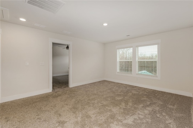 carpeted empty room featuring recessed lighting, baseboards, and visible vents