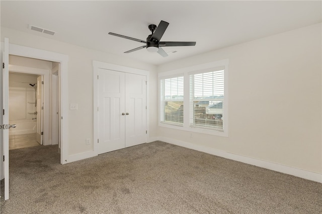 unfurnished bedroom with visible vents, ceiling fan, baseboards, carpet floors, and a closet