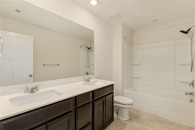 bathroom with double vanity, toilet, visible vents, and a sink