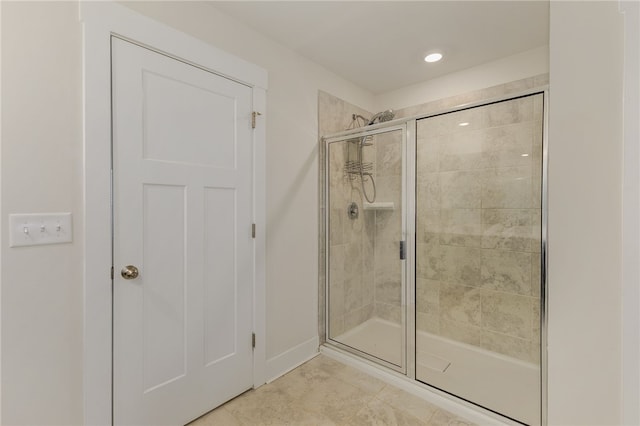 bathroom featuring tile patterned floors and a stall shower