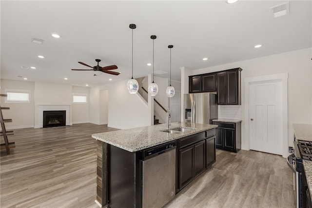 kitchen with a sink, visible vents, light wood-style floors, and appliances with stainless steel finishes