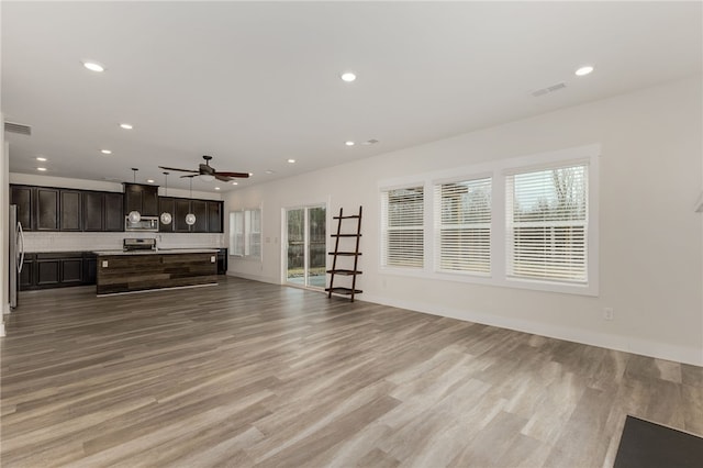 living area featuring recessed lighting, visible vents, and light wood-style flooring