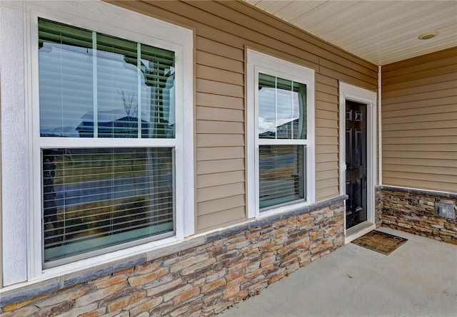 property entrance with stone siding