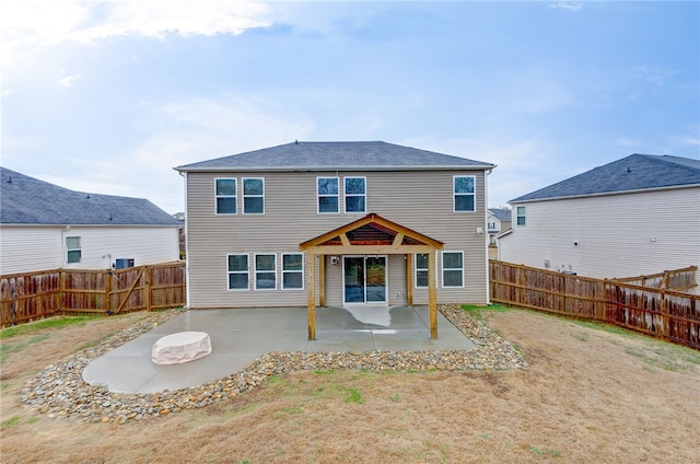 back of house featuring a patio area and a fenced backyard