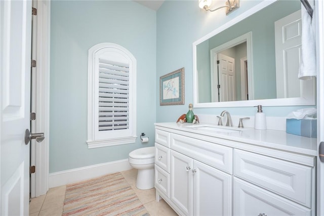 bathroom with tile patterned floors, toilet, vanity, and baseboards