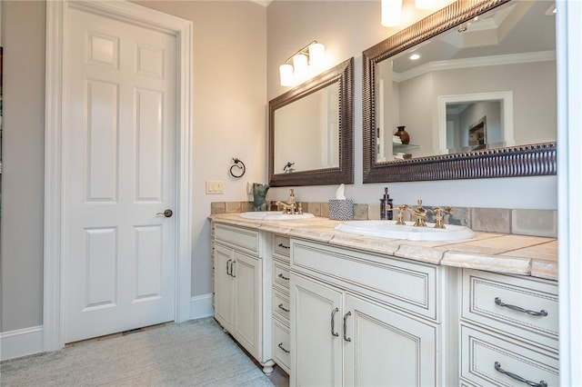 full bath with double vanity, crown molding, and a sink