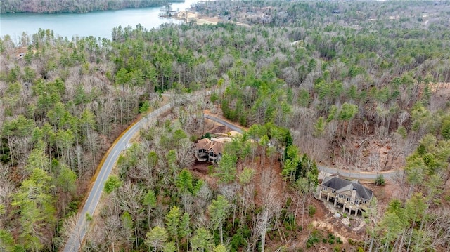 aerial view featuring a forest view and a water view