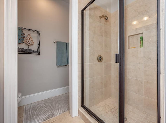 full bathroom with tile patterned flooring, toilet, baseboards, and a stall shower