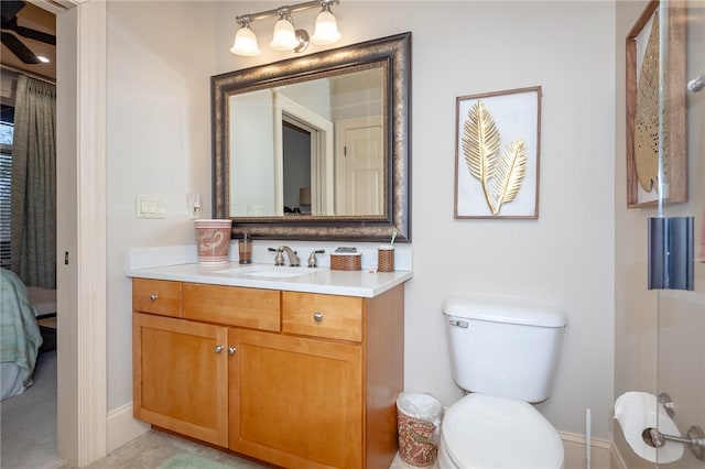 bathroom featuring toilet, ensuite bath, ceiling fan, and vanity