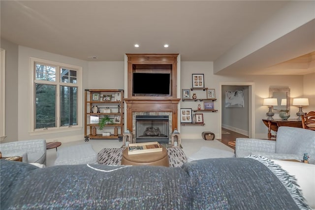 living room with recessed lighting, baseboards, and a fireplace