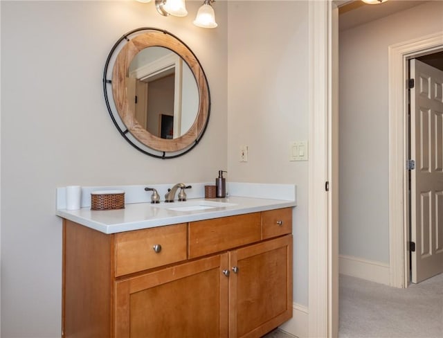 bathroom with baseboards and vanity