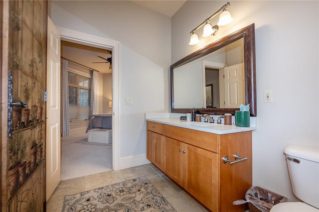 bathroom featuring tile patterned flooring, toilet, vanity, and baseboards