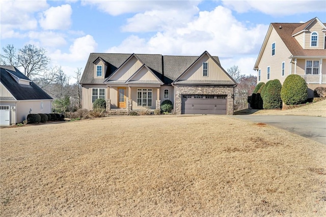 view of front facade featuring concrete driveway, a garage, and stone siding