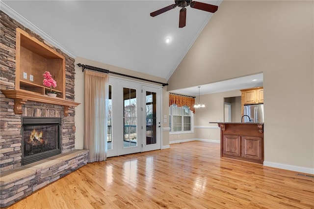 114 Royal Troon, Campobello, SC 29322 - unfurnished living room featuring ceiling fan with notable chandelier, a fireplace, baseboards, and light wood finished floors