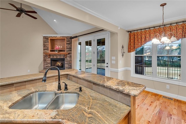 114 Royal Troon, Campobello, SC 29322 - kitchen with light stone countertops, open floor plan, ornamental molding, a fireplace, and a sink